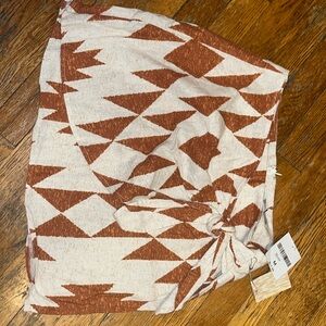 A short skirt, color cream/rust with a bow & slit- brand new with tag